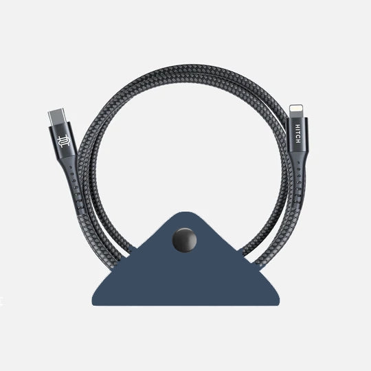 Durable braided USB-C cable with reinforced connectors, displayed in loop shape on solid cord wrap on a gray background.