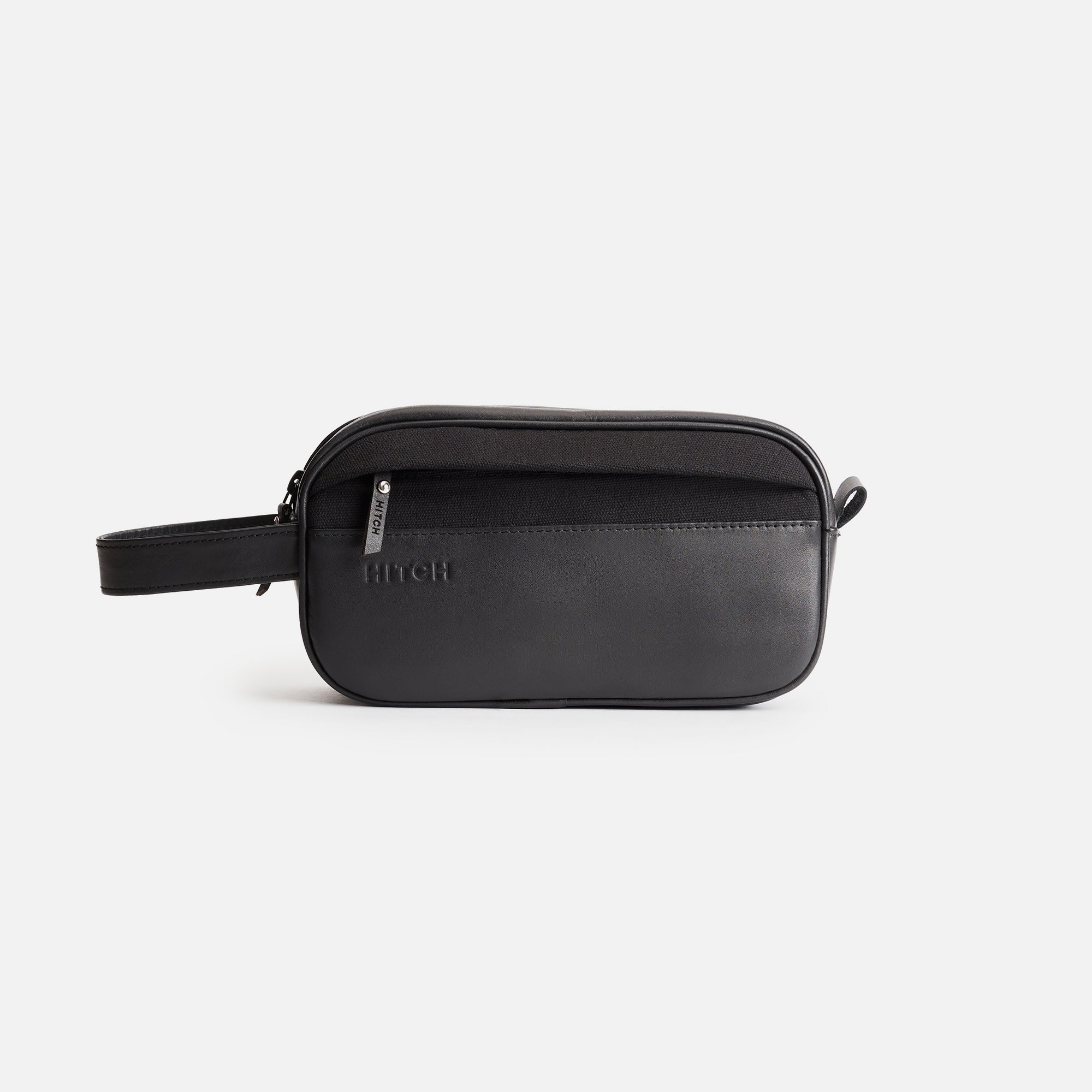 Black leather dopp kit with brand logo "HITCH" embossed on white background.