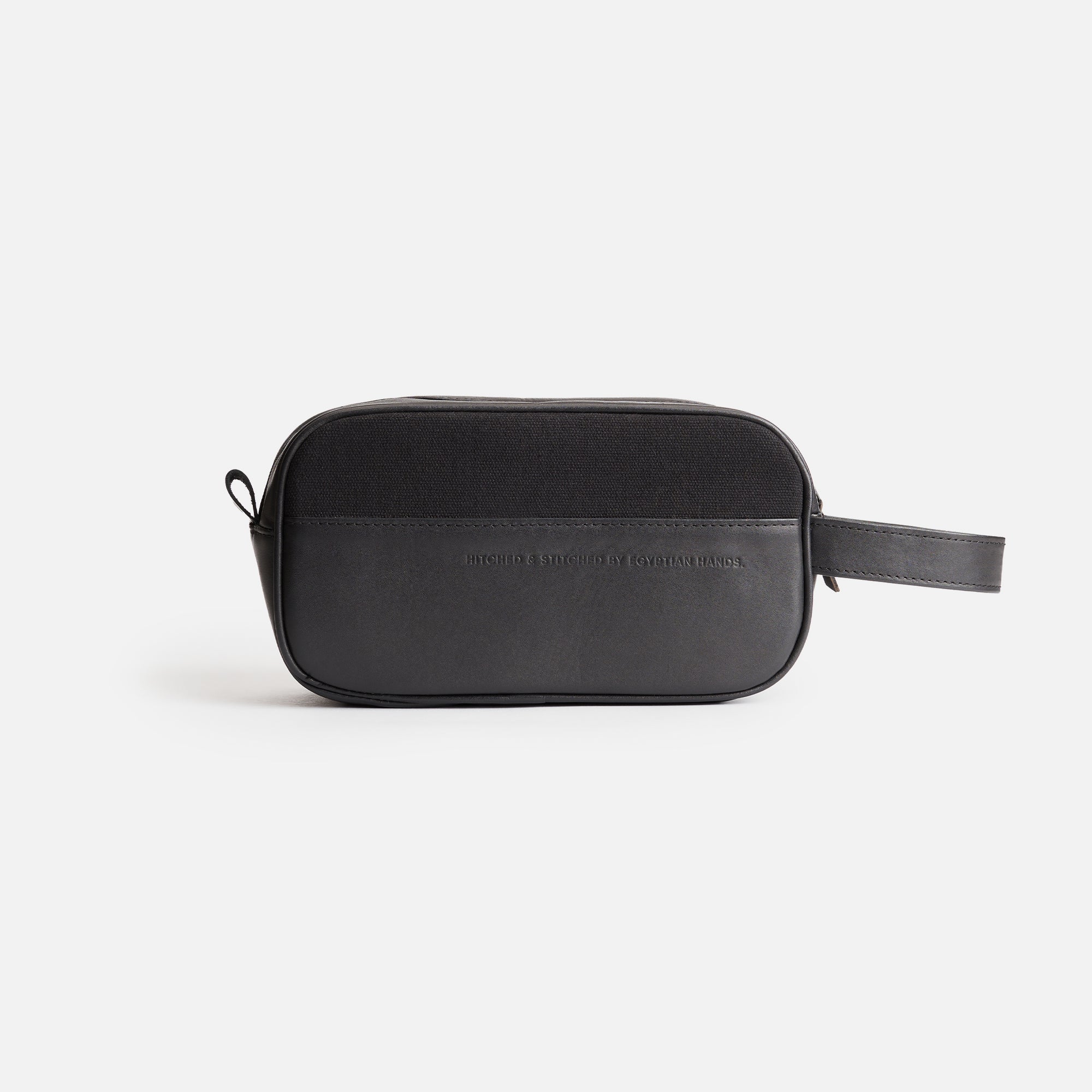 Black designer toiletry bag with brand logo "HITCH" embossed on white background.