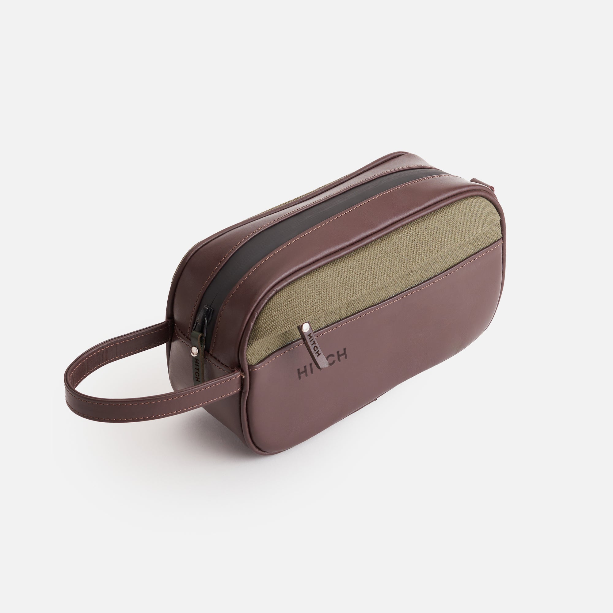 Brown and olive dopp kit with wrist strap, embossed HITCH, on a white background.