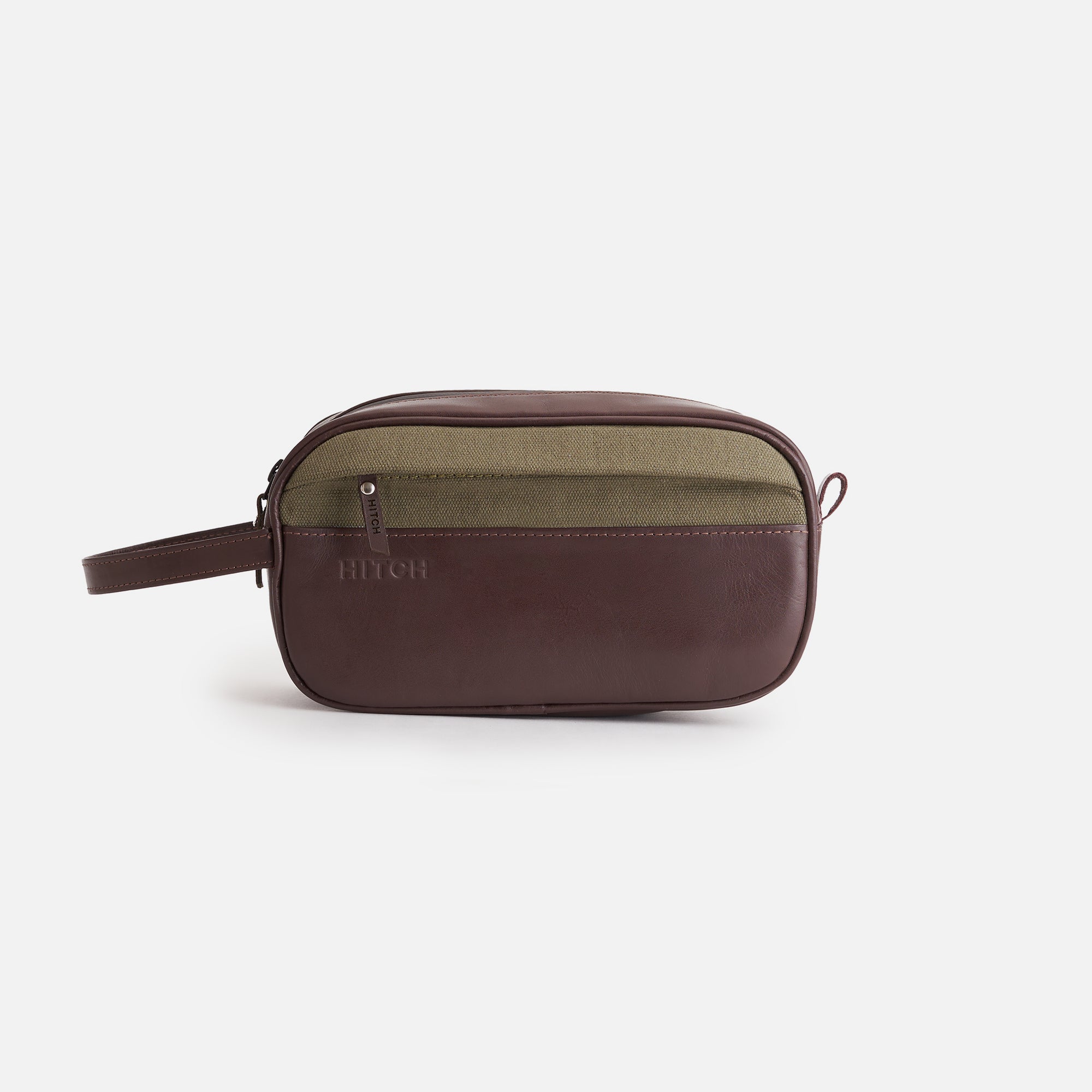 Brown and olive stylish toiletry bag with wrist strap and brand logo embossed on a white background.