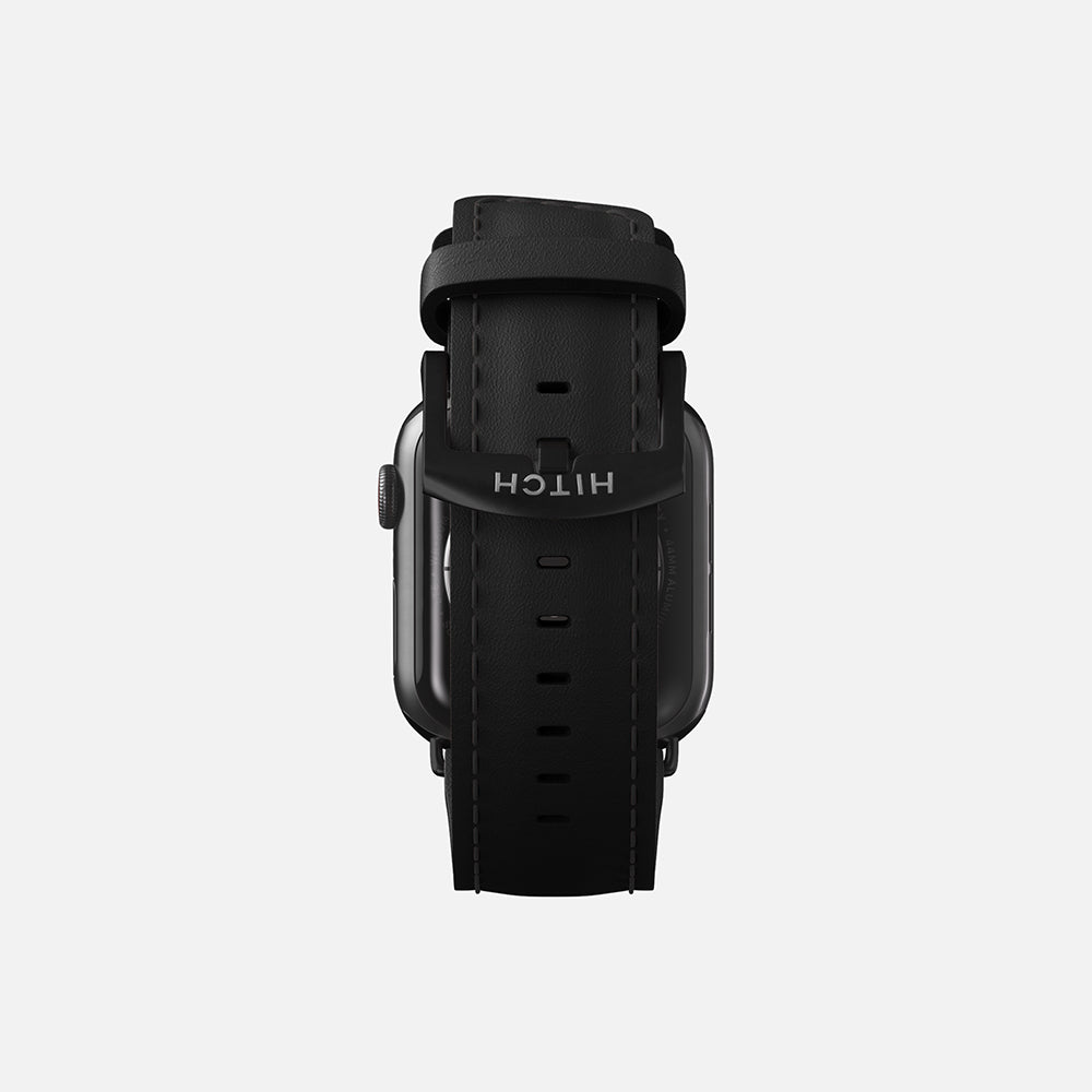 Apple smartwatch with black leather strap on a white background.