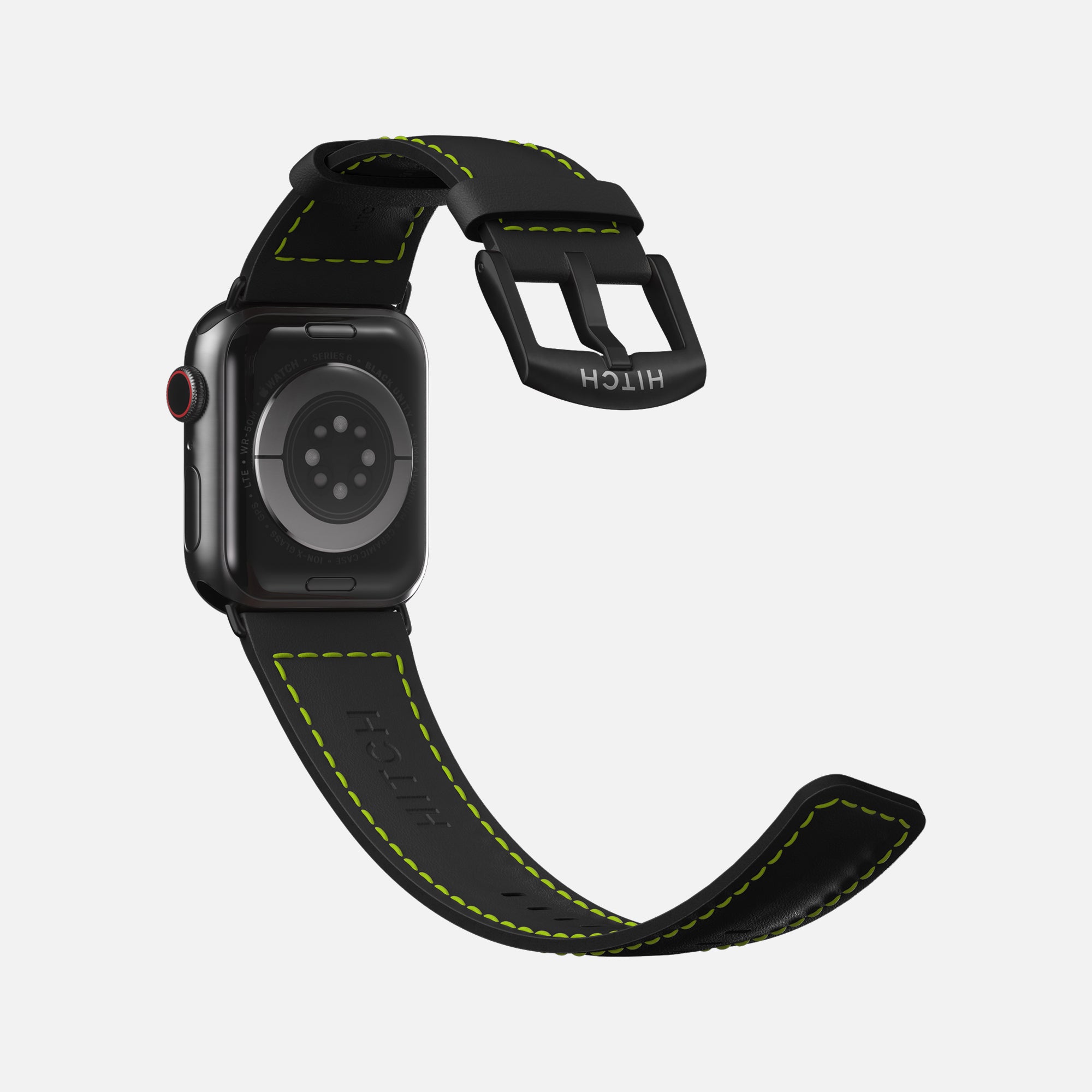 Black Apple smartwatch with green stitching and branded black strap on white background.